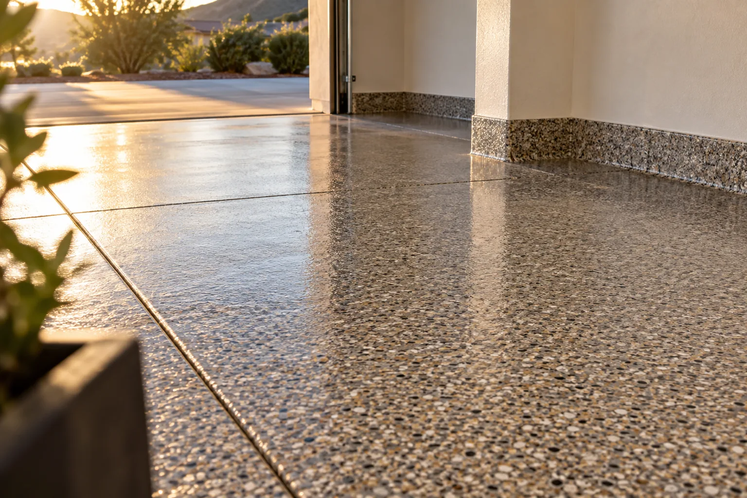Low view across a garage floor in a gravel-look gray, tan and brown flake blend under a crystal-clear glossy finish